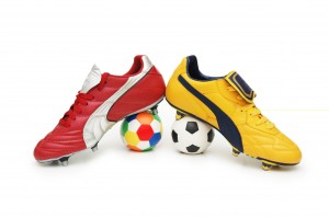 Soccer footwear and color footballs isolated on white
